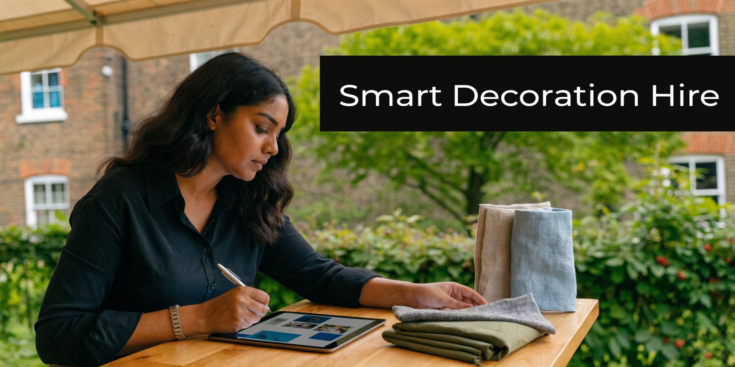A professional woman uses a digital tablet while choosing fabric samples for an event decoration service.
