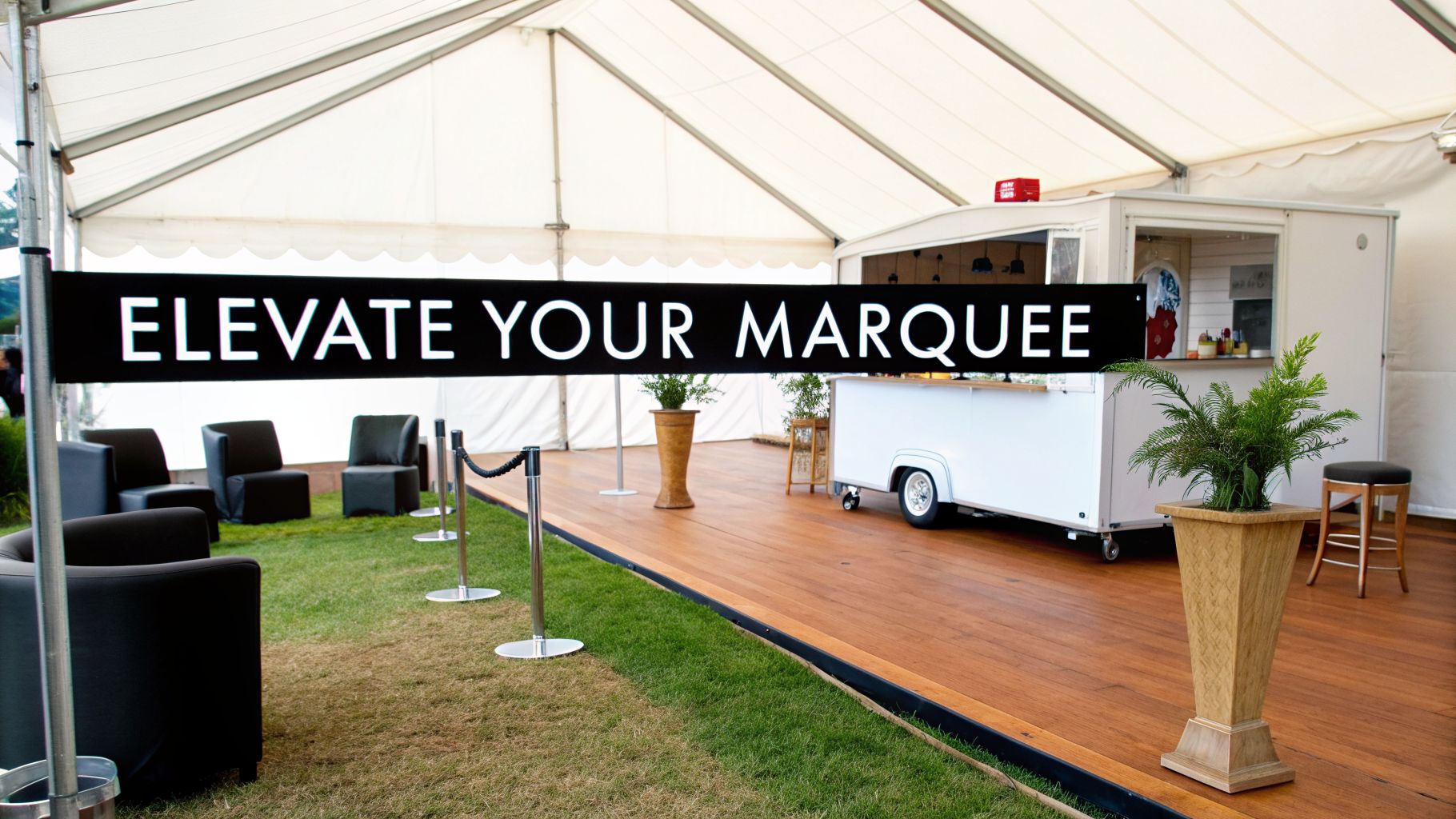 A stylish white event marquee interior with a 'ELEVATE YOUR MARQUEE' banner, lounge seating, and a mobile bar.