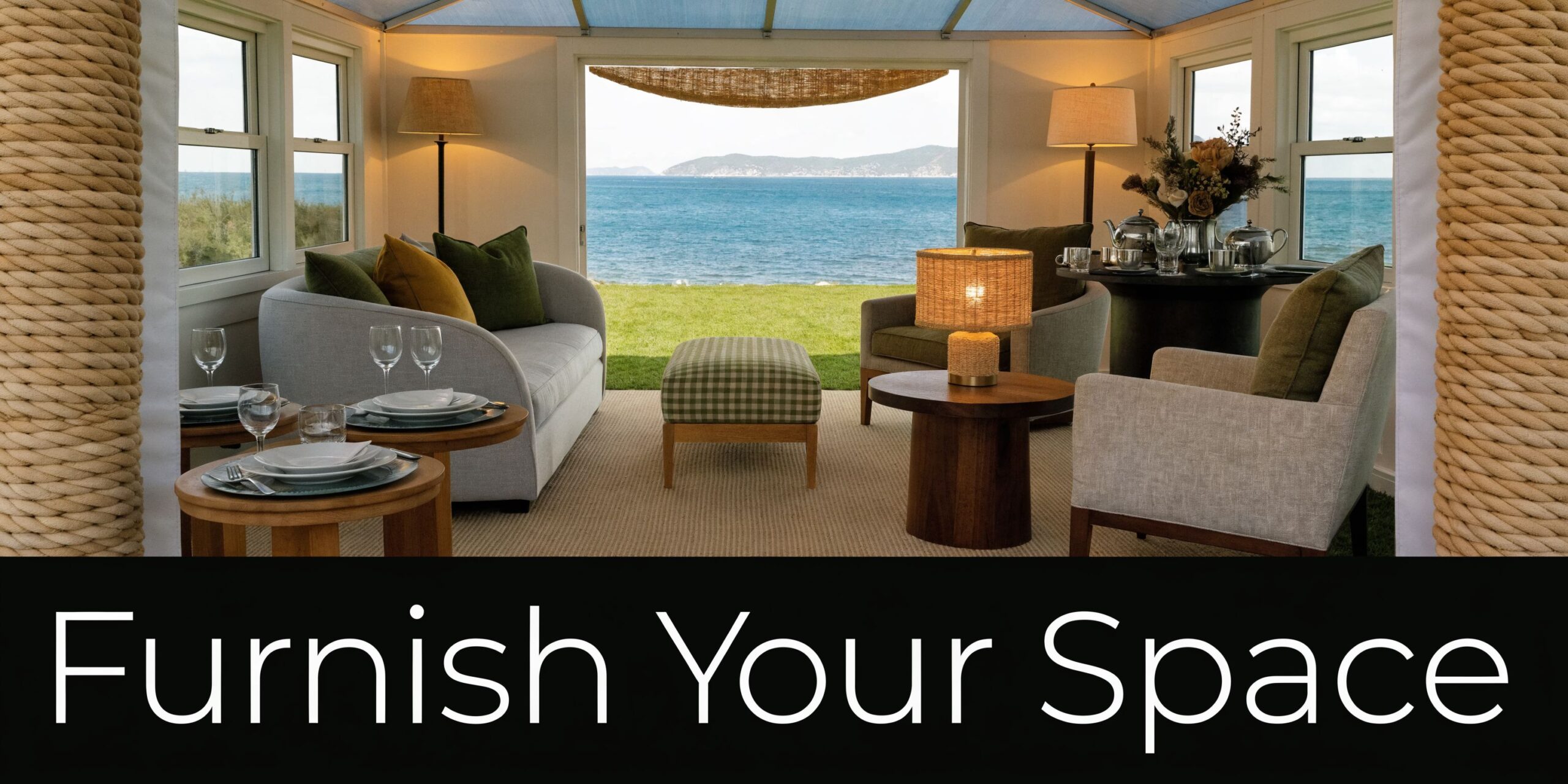 A cozy, sunlit sunroom overlooking the ocean with comfortable seating, dining areas, and a relaxing coastal view.