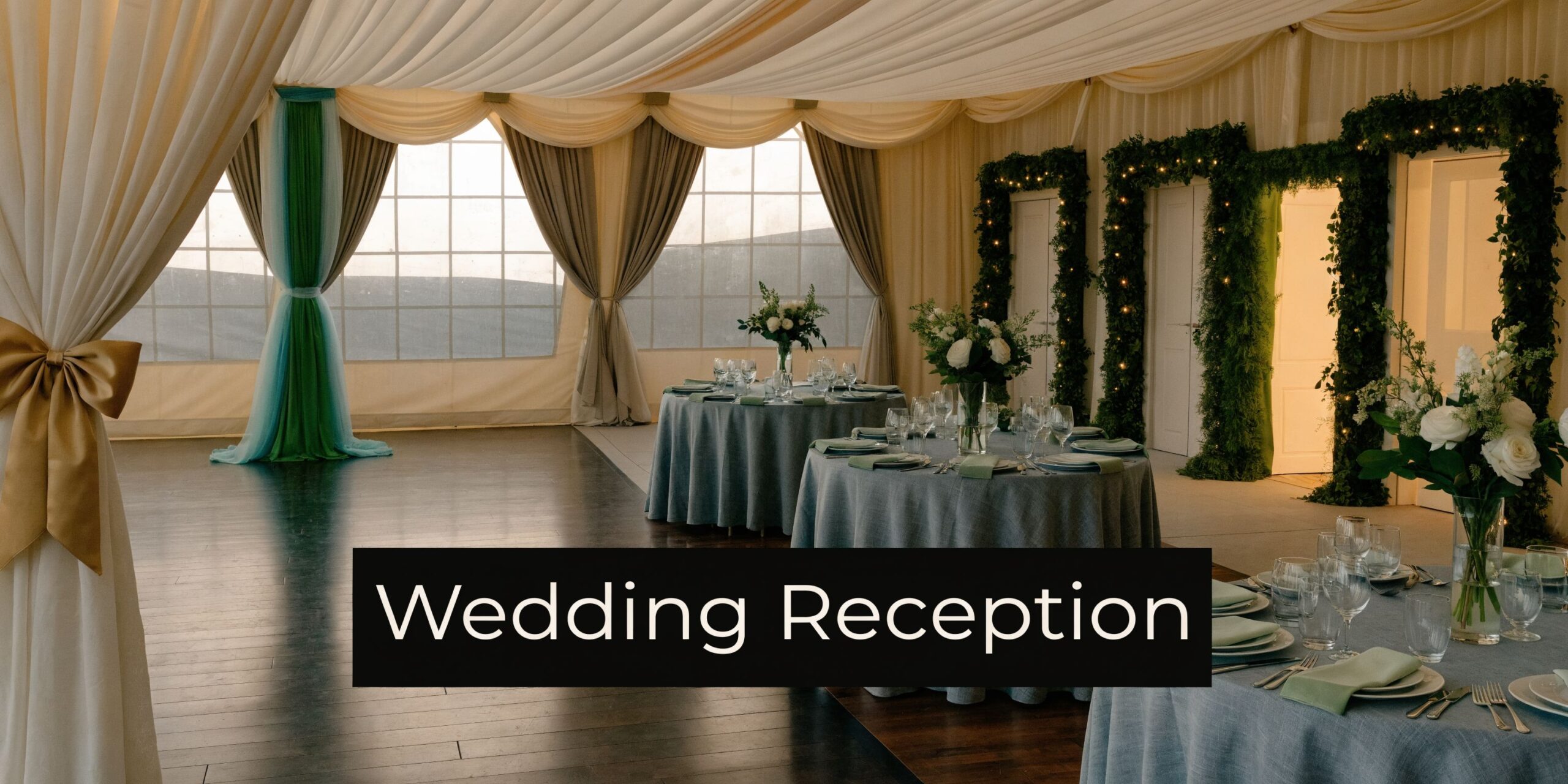 An elegant wedding reception setup in a decorated marquee with round tables featuring floral centerpieces.