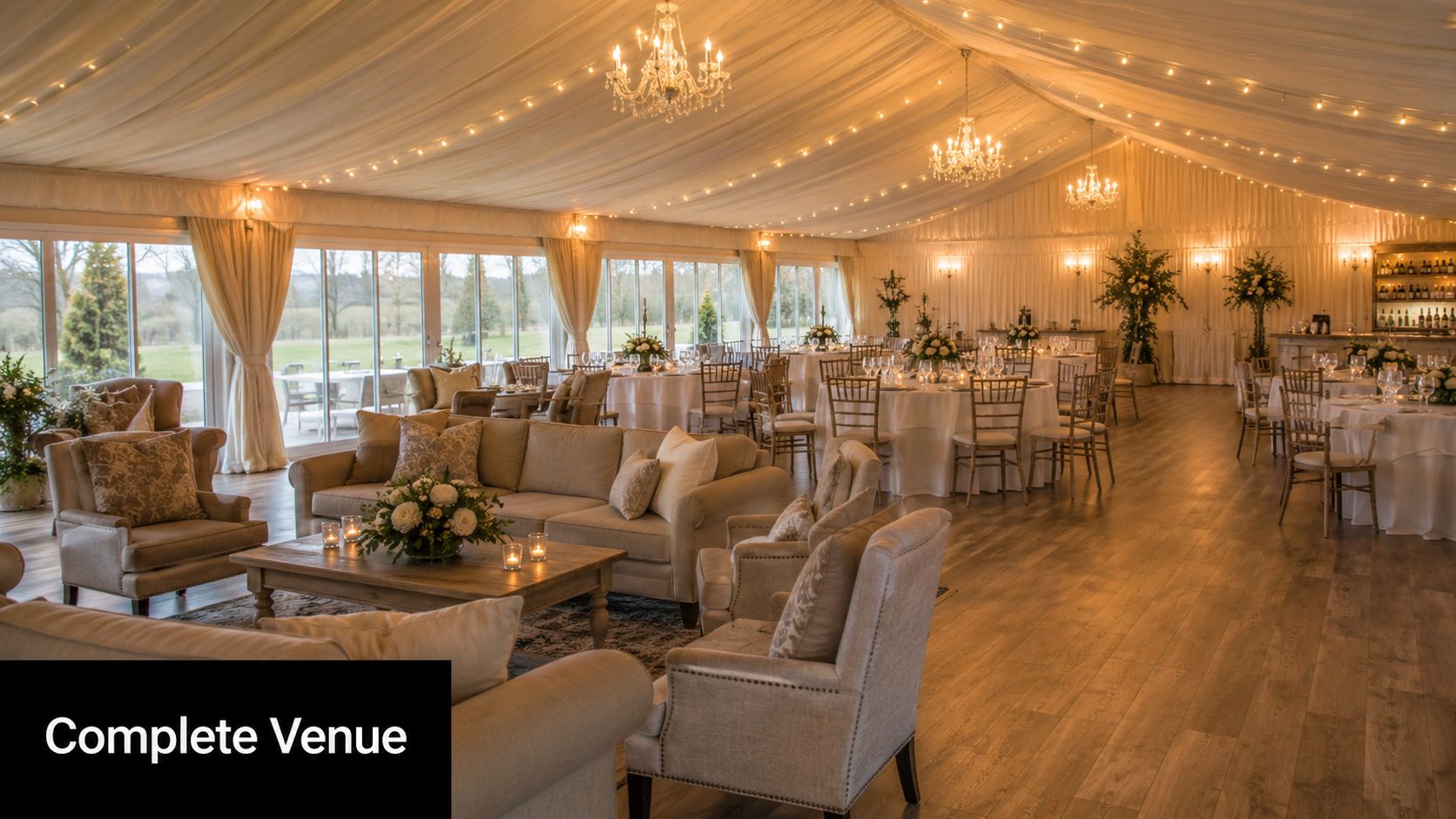 A luxurious wedding marquee venue in Croydon Surrey featuring elegant sofas and round banquet dinner tables.