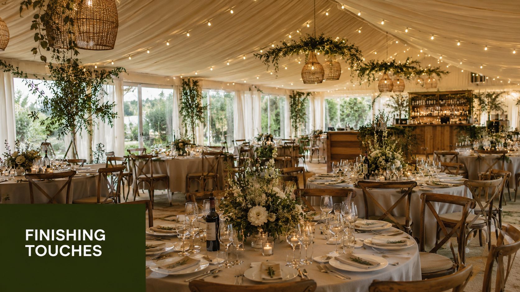 An elegant wedding reception inside a marquee tent decorated with warm string lights and floral centerpieces.